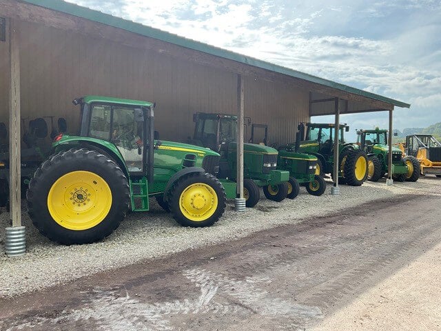 John Deere Tractor Lineup Under Bill's Tractors Awning
